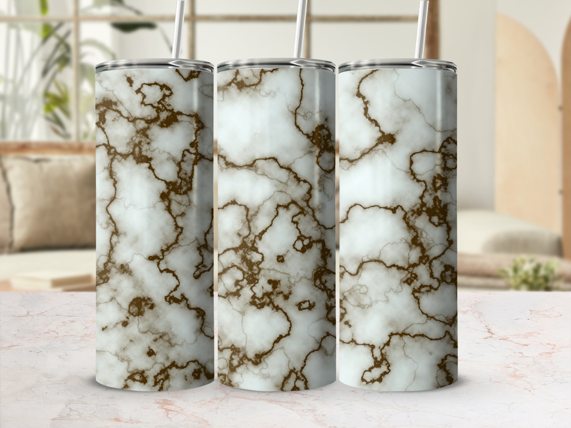 Three tumblers with white and brown marble pattern and straws.