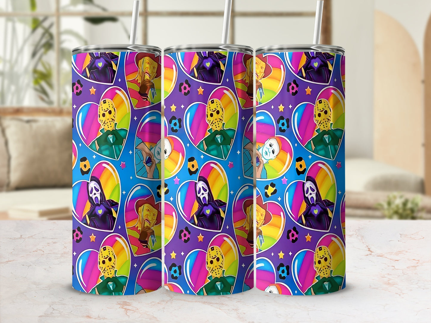 Three tumblers with horror characters and hearts pattern, on a marbled surface.
