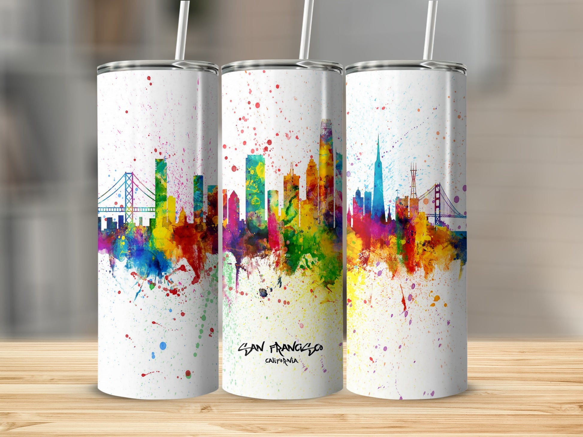 Three tumblers feature a colorful watercolor San Francisco skyline with paint splatters.