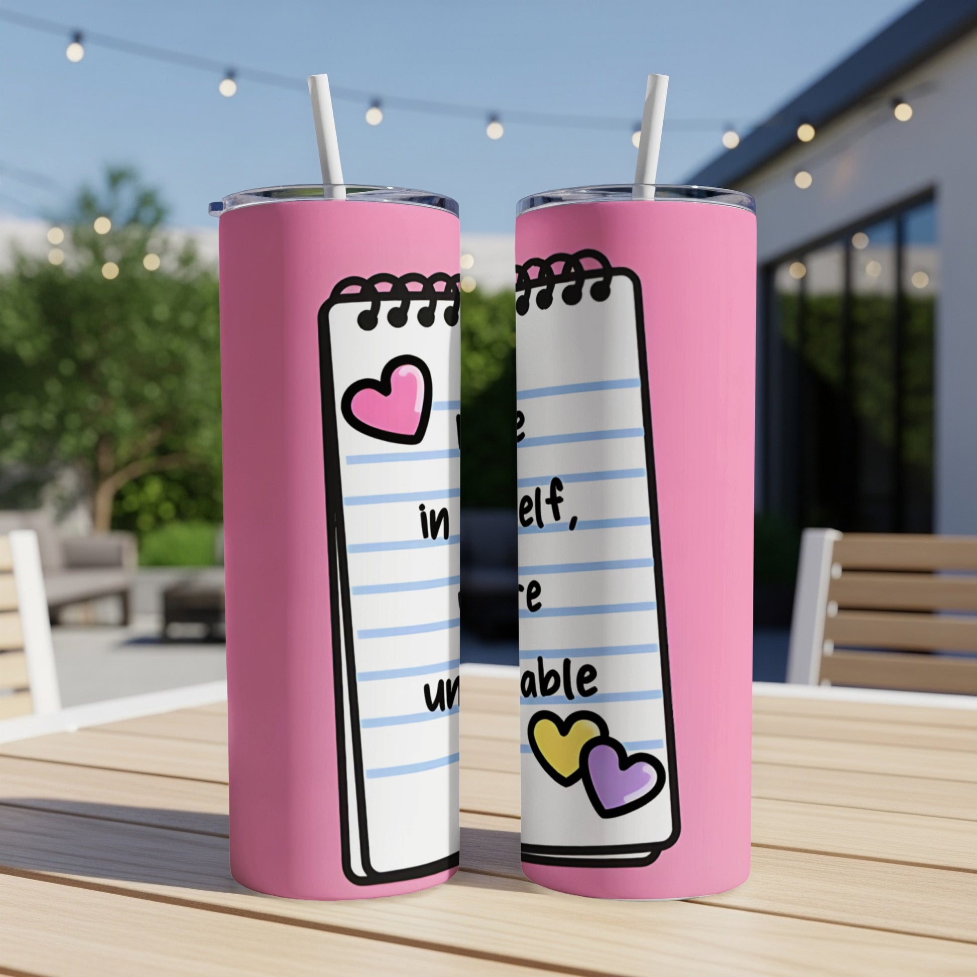 Pink tumbler with spiral notebook design featuring hearts and text.