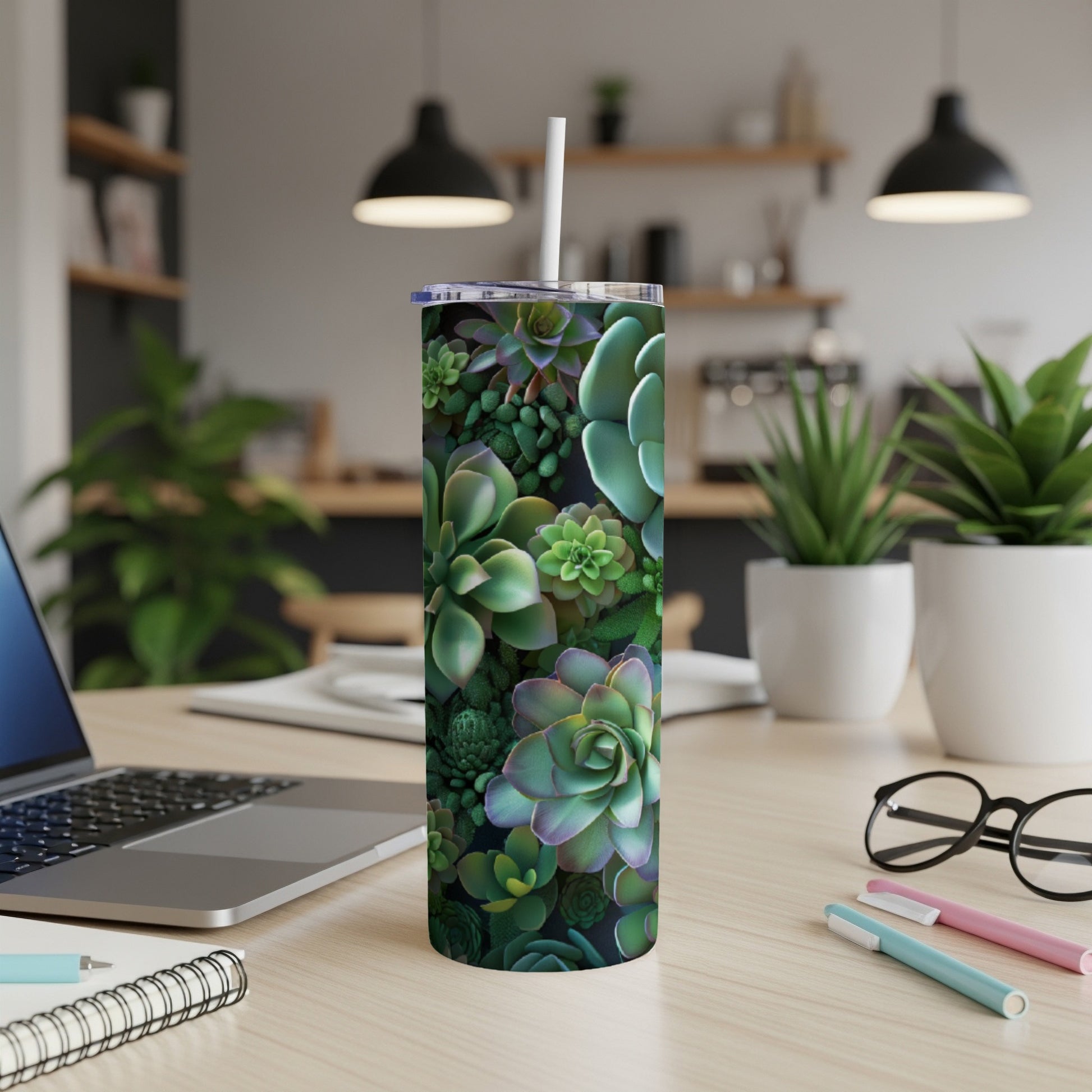 Succulent plant pattern on a tall, white insulated tumbler with a straw.