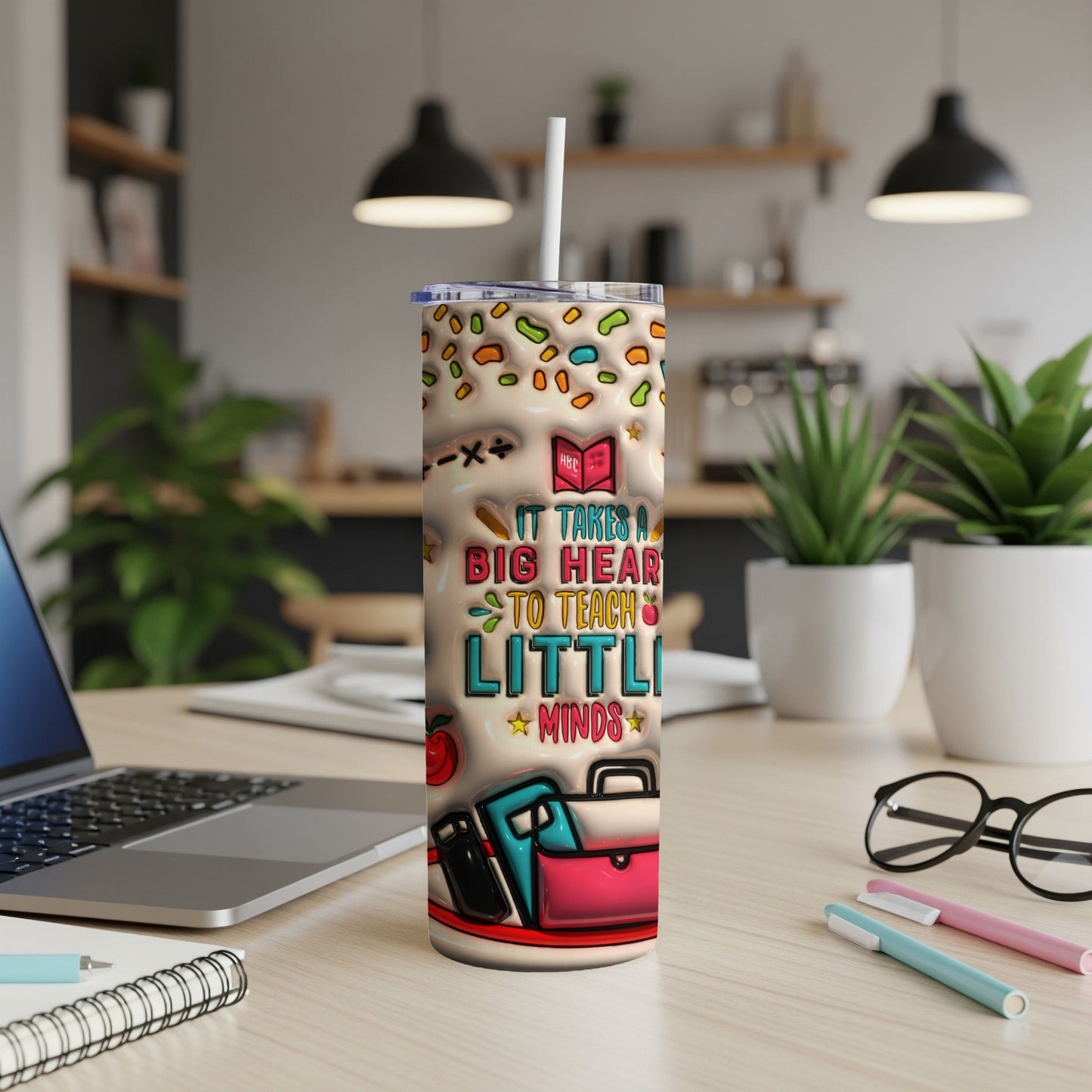 Tumbler with "It Takes A Big Heart To Teach Little Minds" text and school icons.