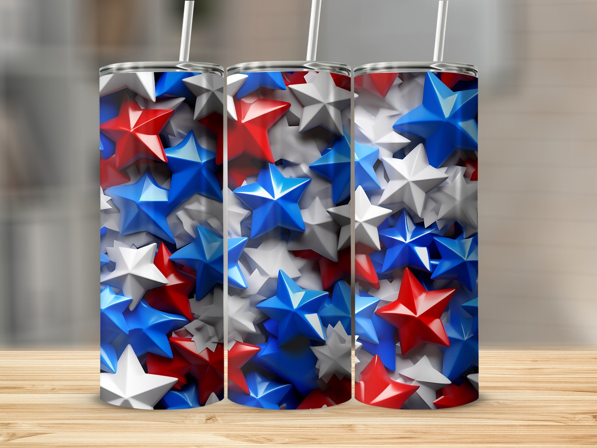 Three tumblers with red, white, and blue star patterns on a wooden surface.