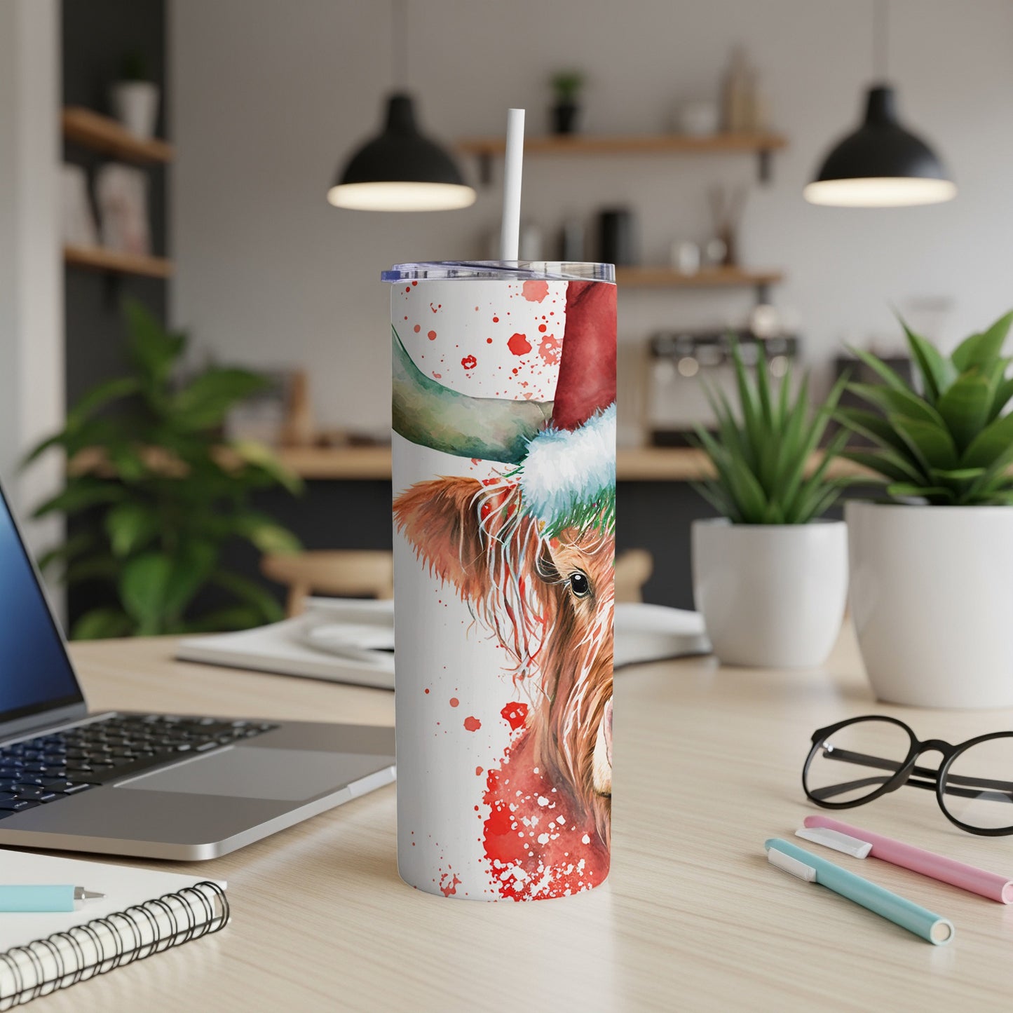 Cow wearing Santa hat on white tumbler with straw.
