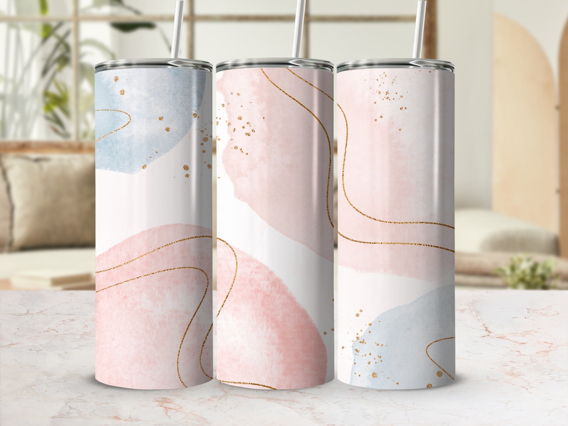 Three tumblers with pastel watercolor and gold glitter abstract designs.