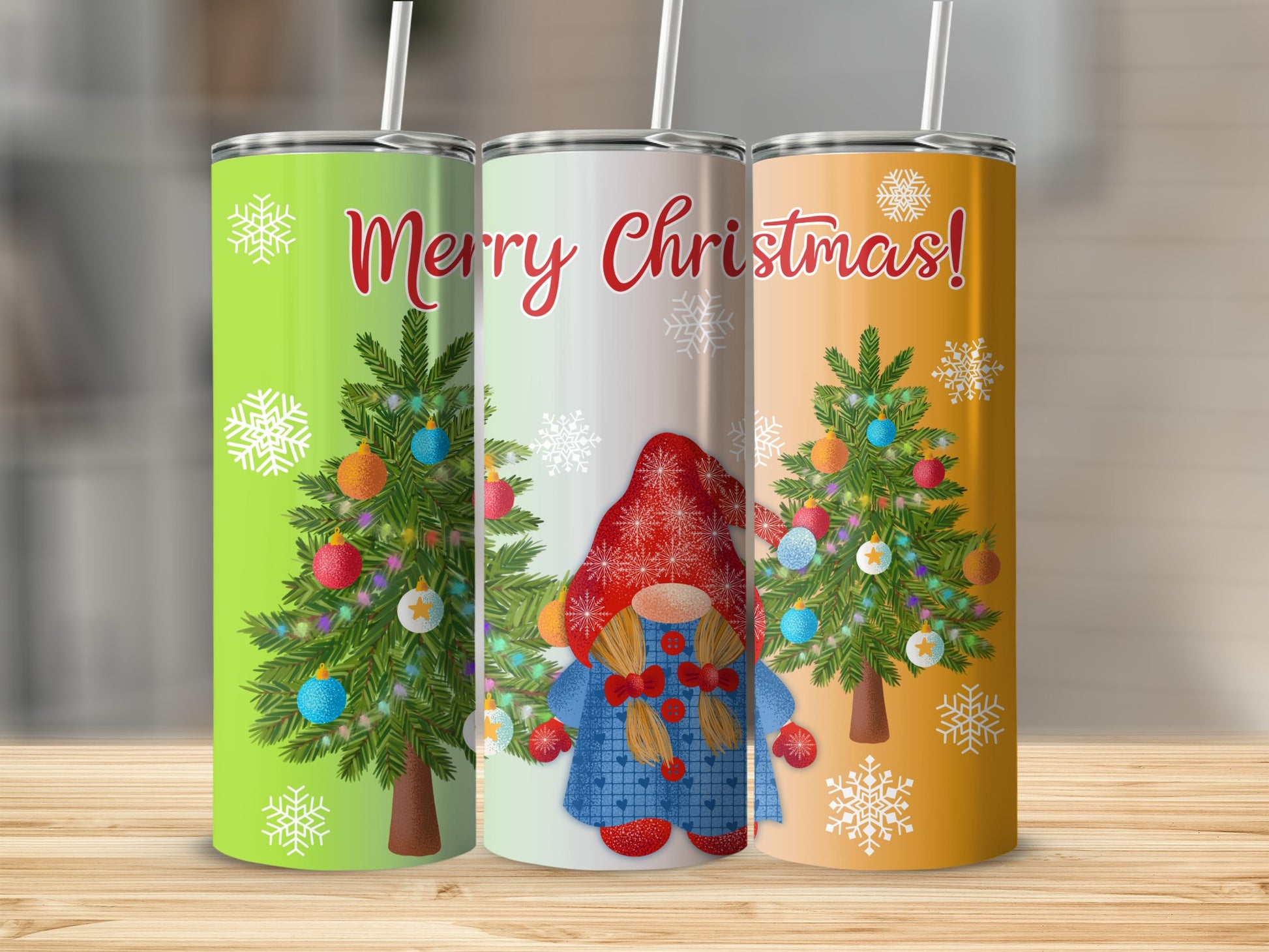 Three tumblers with Christmas trees and a gnome, one green, one silver, one orange.