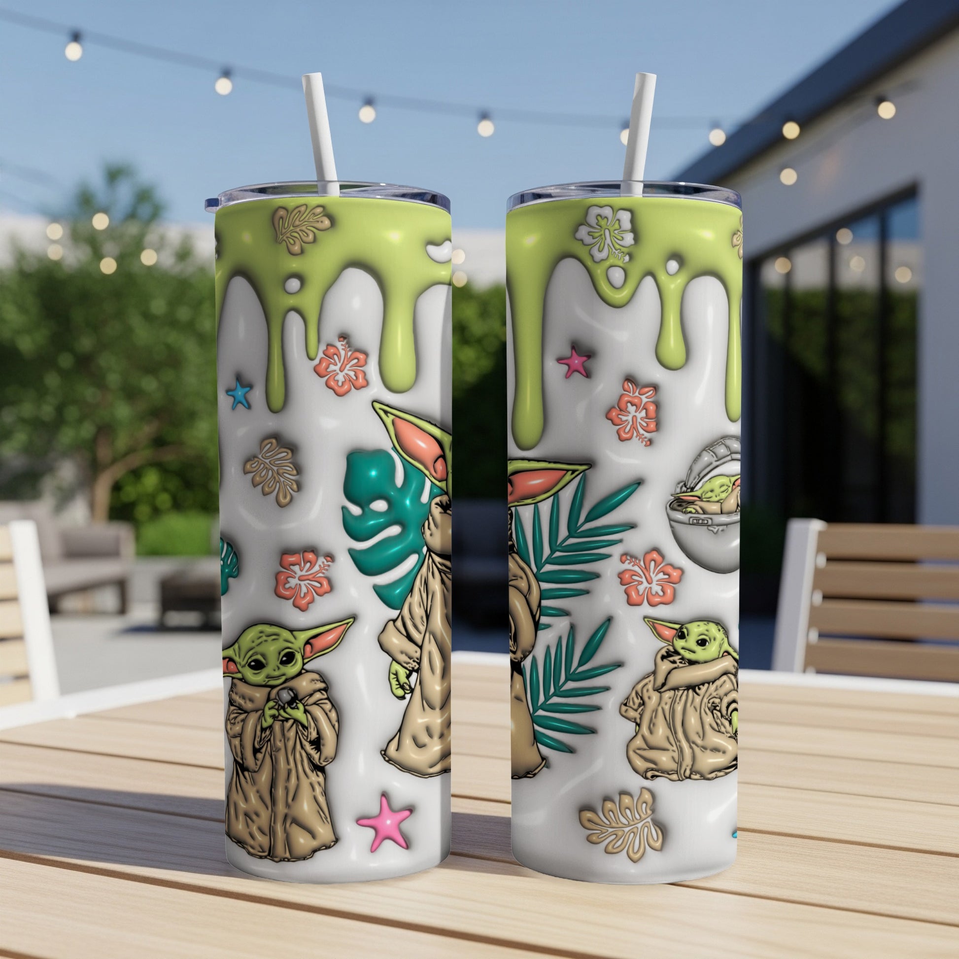Two tall tumblers with a baby alien character and floral design.