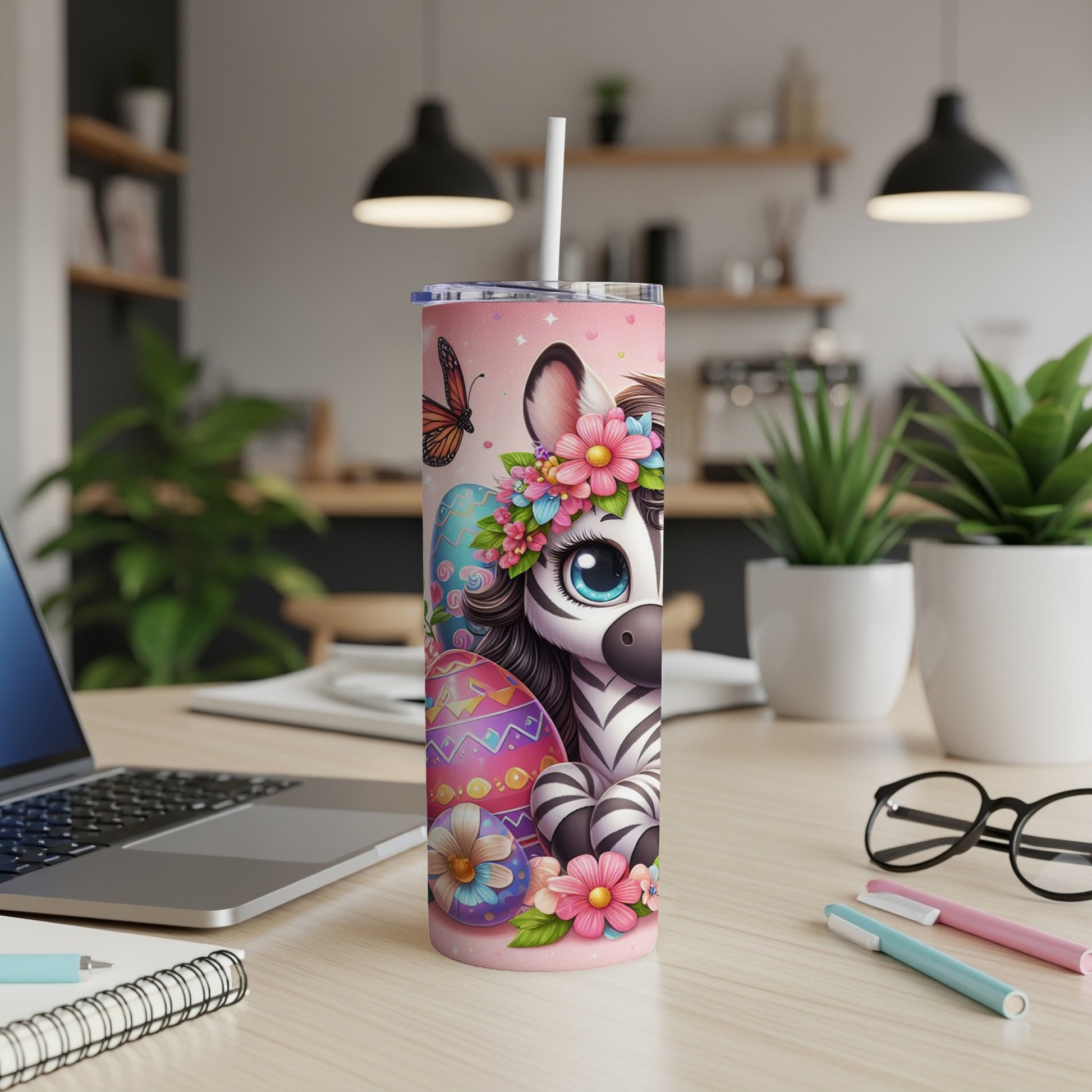 Pink tumbler with a smiling zebra, Easter eggs, and flowers.