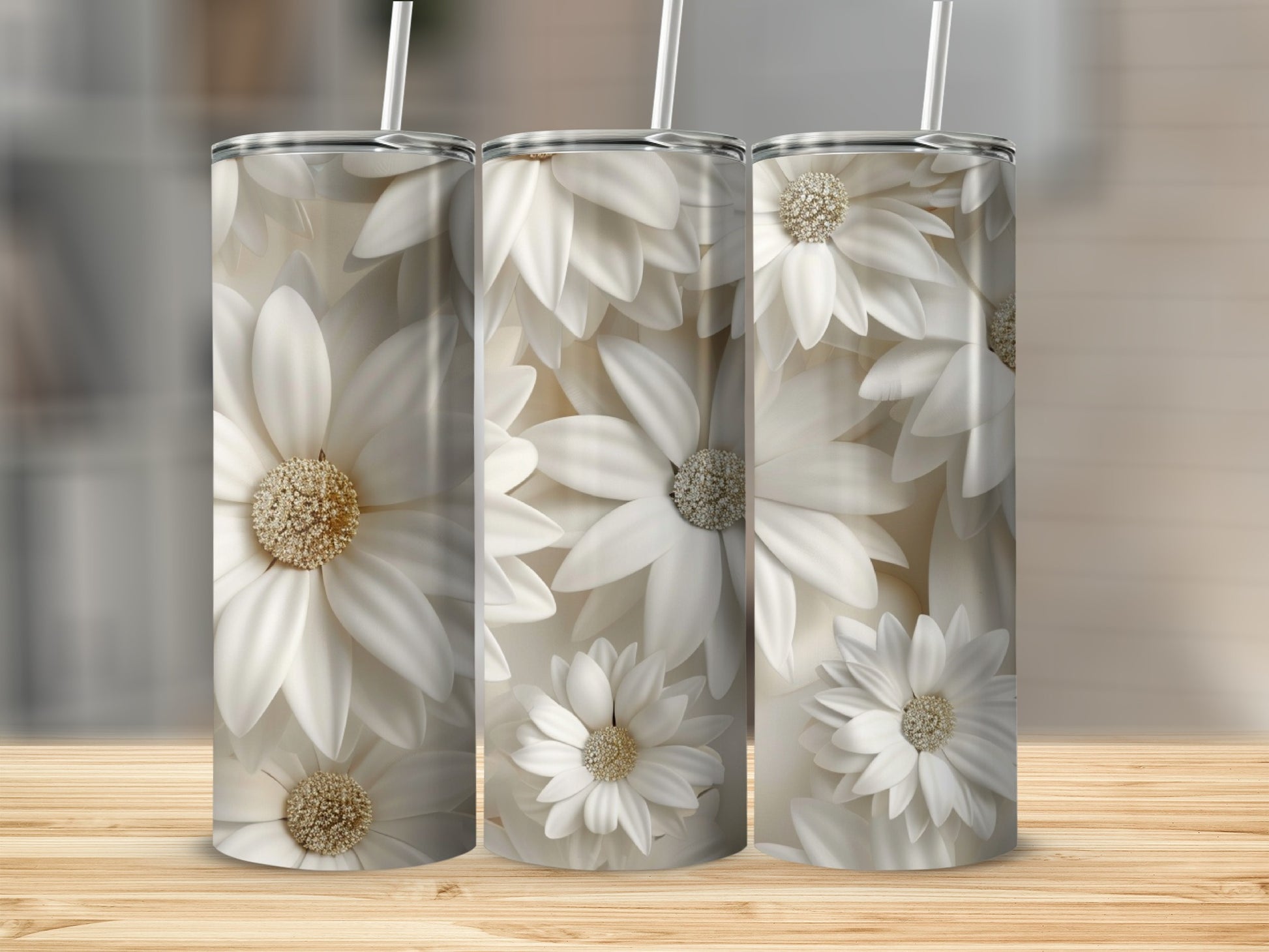 Three tumblers with a white floral pattern and straws on a wooden surface.