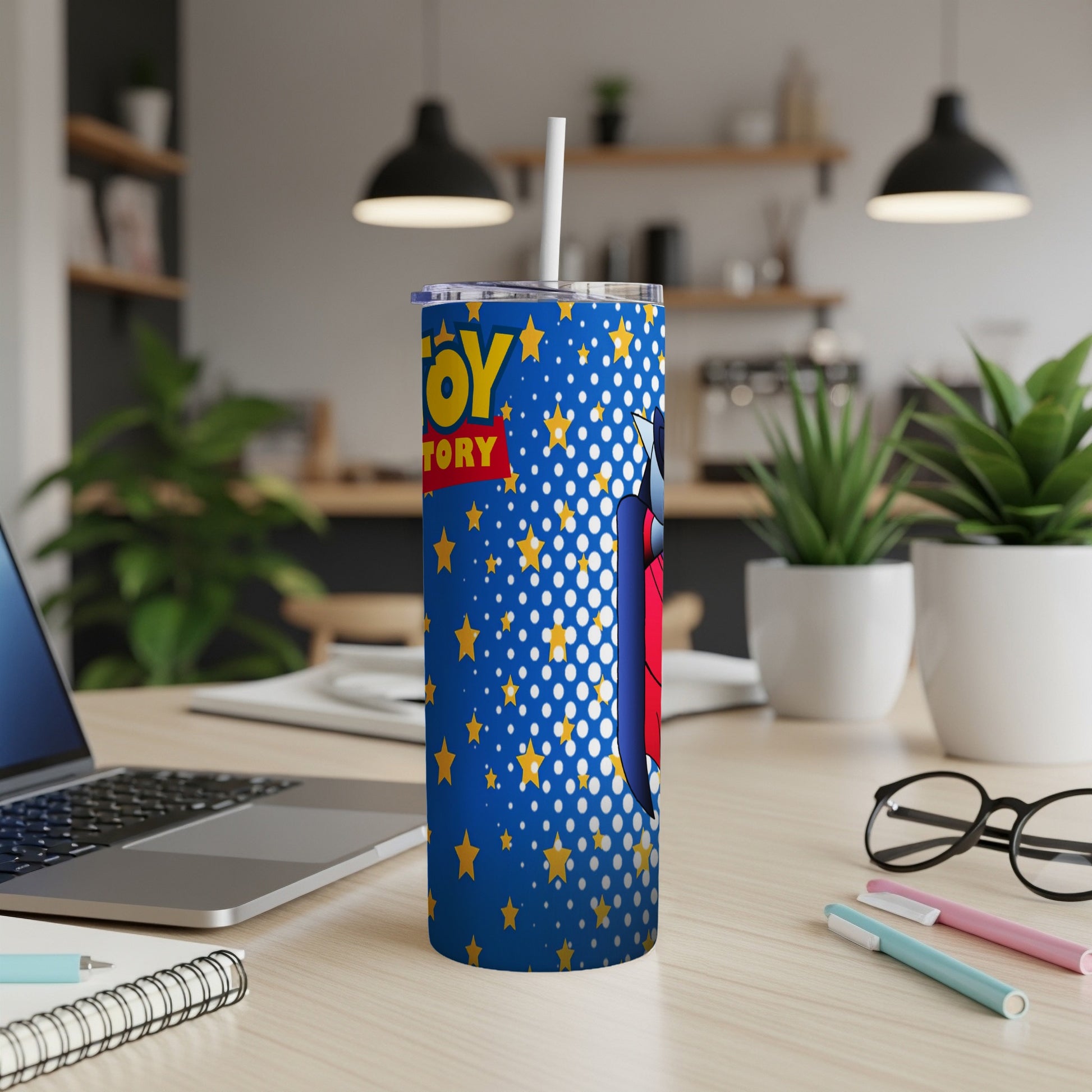 Blue tumbler with Toy Story characters and yellow stars, straw inserted.