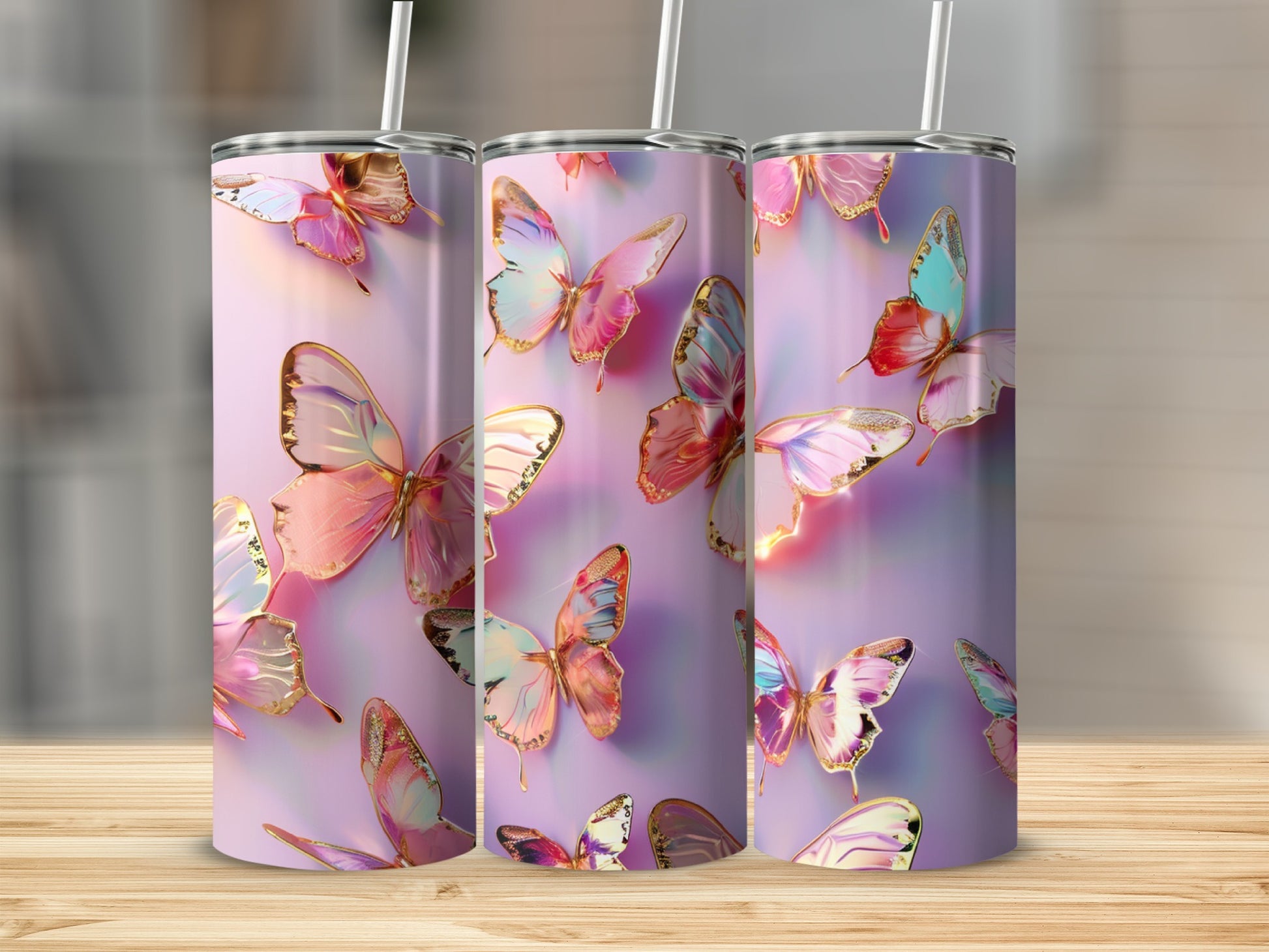 Three tumblers with iridescent butterfly designs on a light pink background.