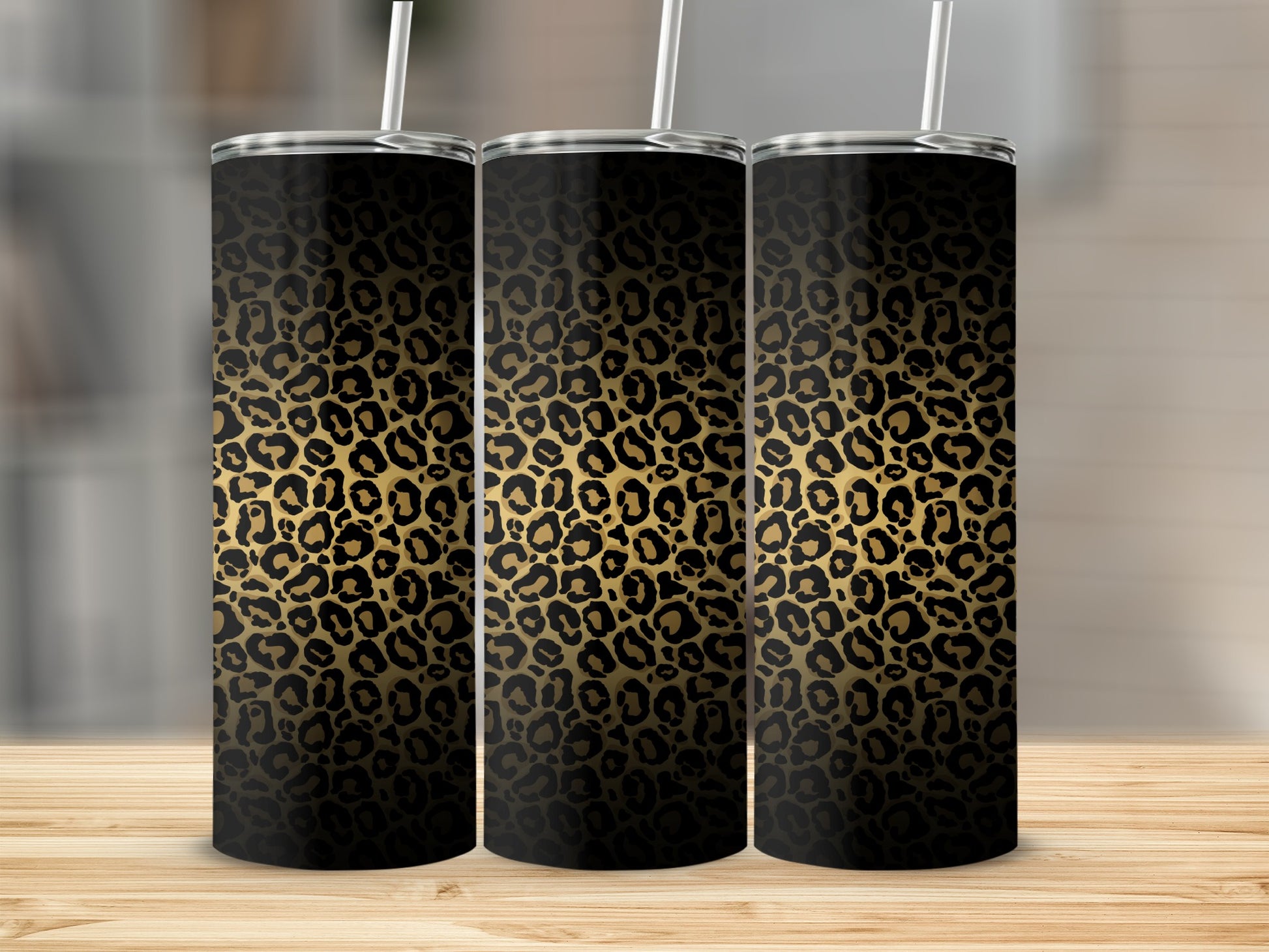 Three tumblers with black and gold leopard print patterns and white straws.