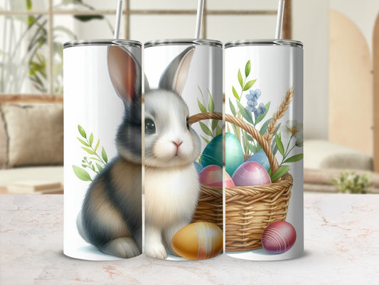 Easter bunny and painted eggs in a basket on tumblers.