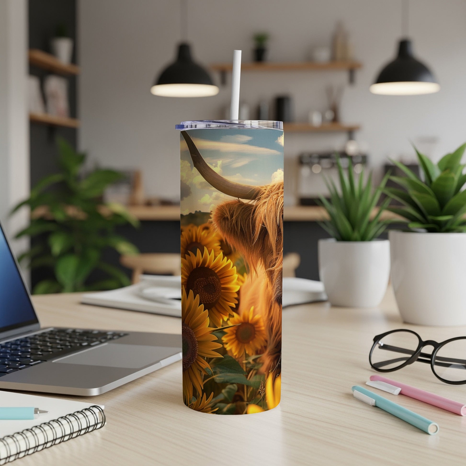 Highland cow in a field of sunflowers on a white tumbler.
