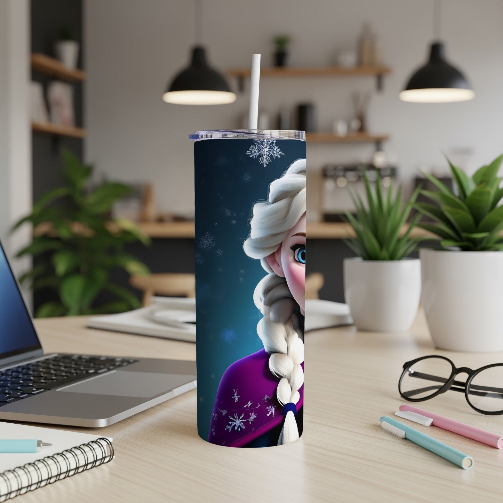 Elsa from Frozen on a blue tumbler with snowflakes and a straw.