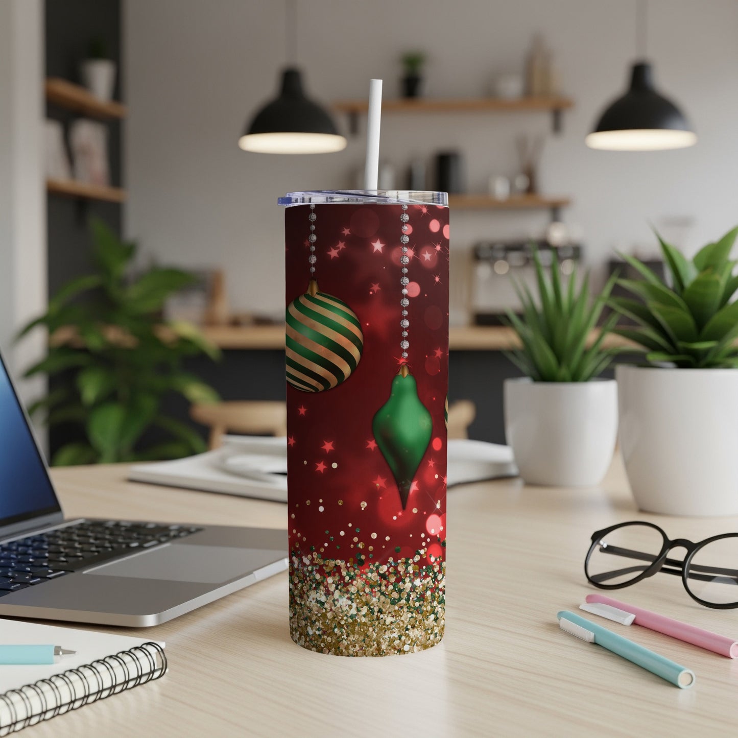Red tumbler with green Christmas ornaments and glitter accents.