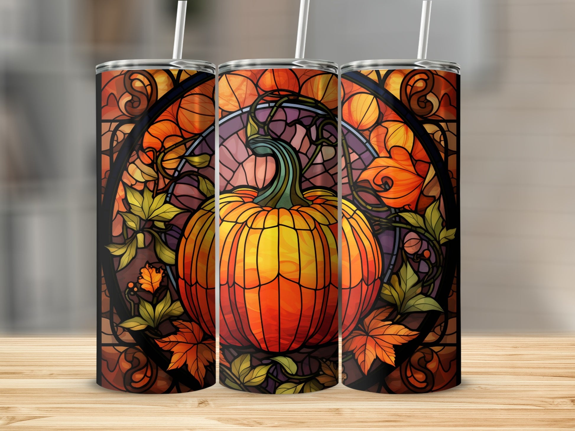 Pumpkin stained glass tumbler with autumn leaves and straw.