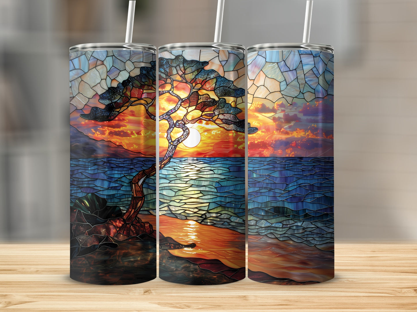 Three tumblers featuring a stained-glass sunset over ocean with a lone tree.