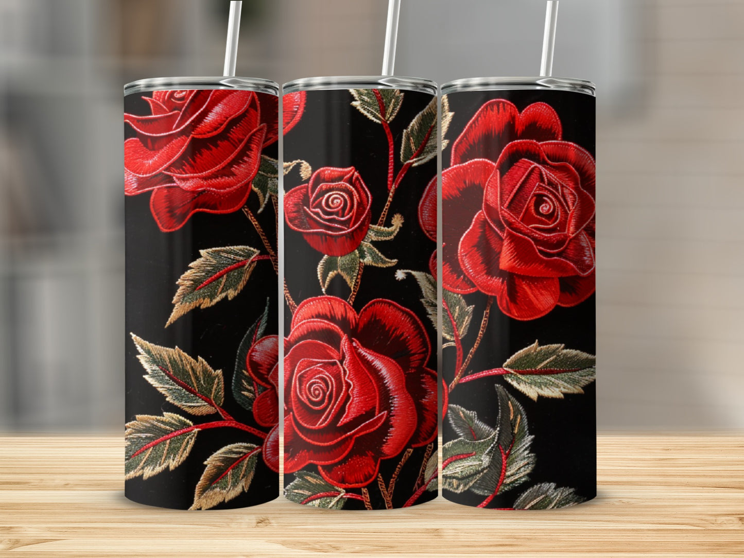 Three tumblers with red embroidered roses on black background.