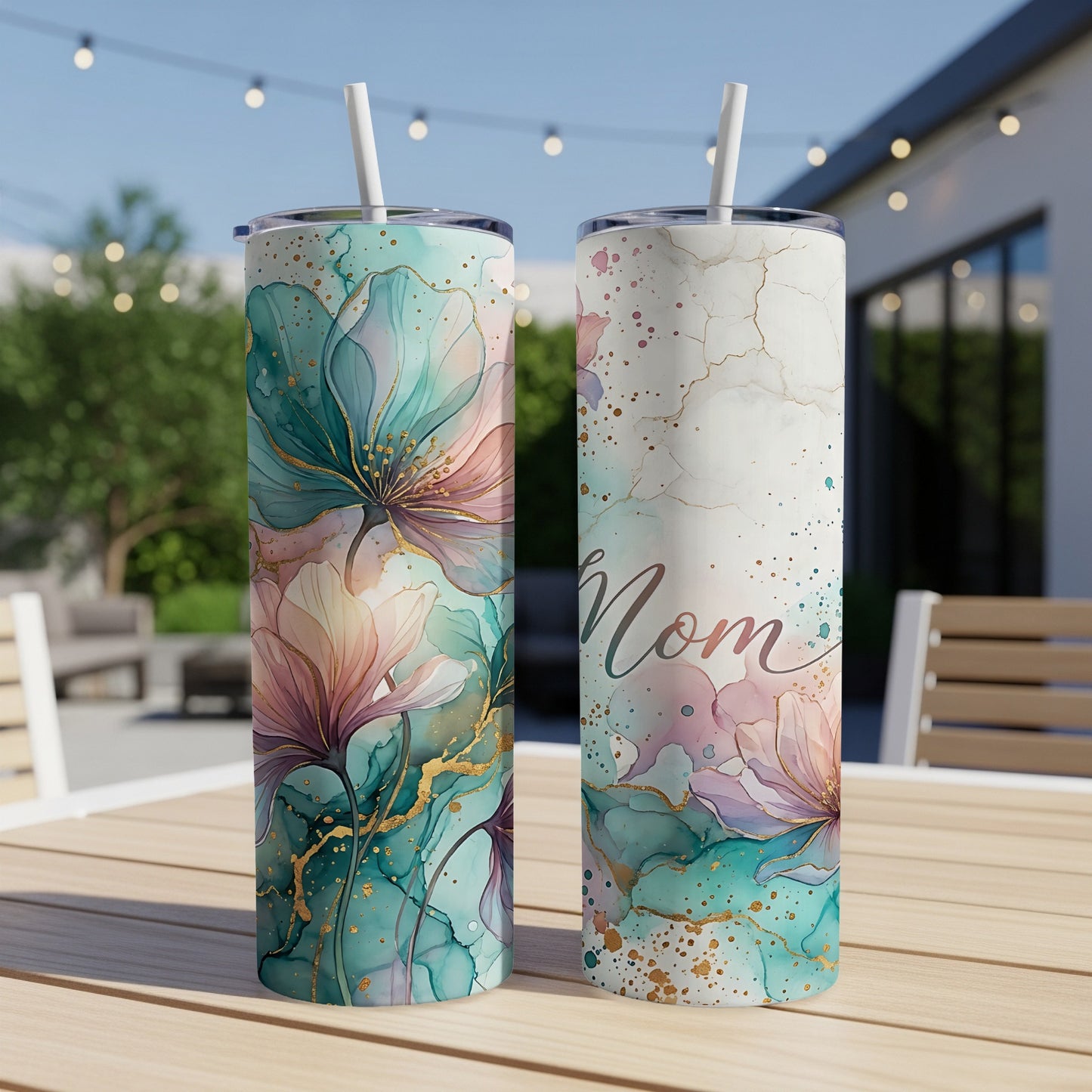 Two floral tumblers with "Mom" text on a table outdoors.