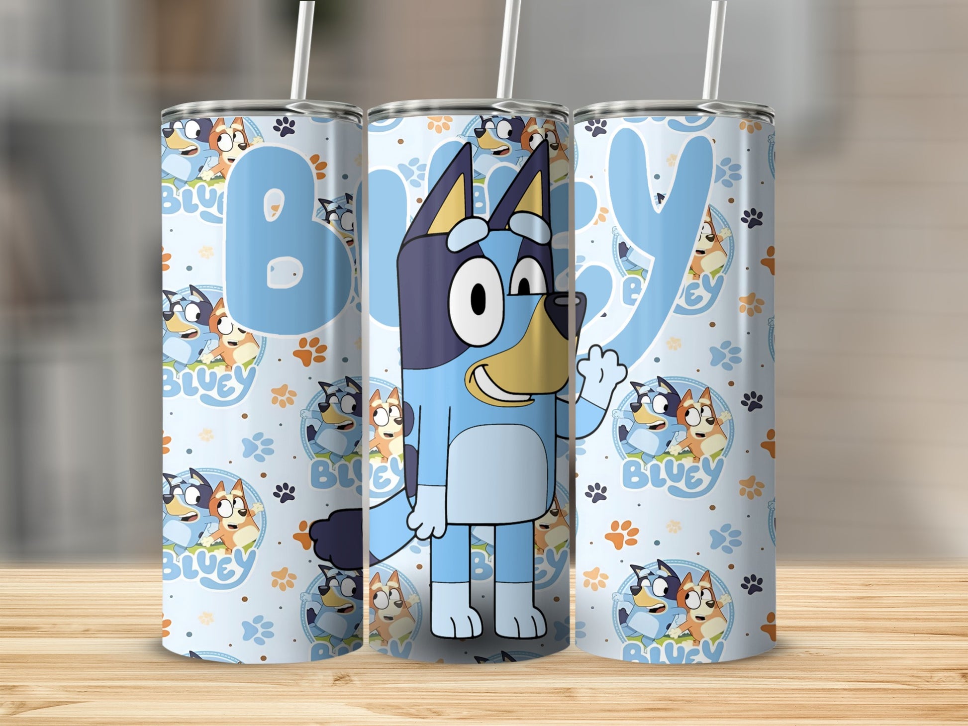 Bluey the cartoon dog on a light blue patterned tumbler with paw prints.