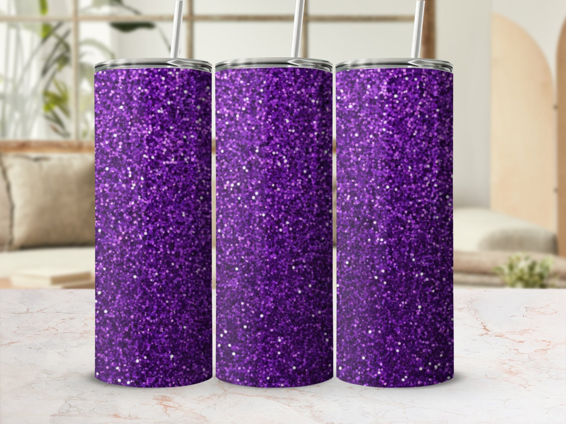 Three purple glitter tumblers with straws on a marble countertop.