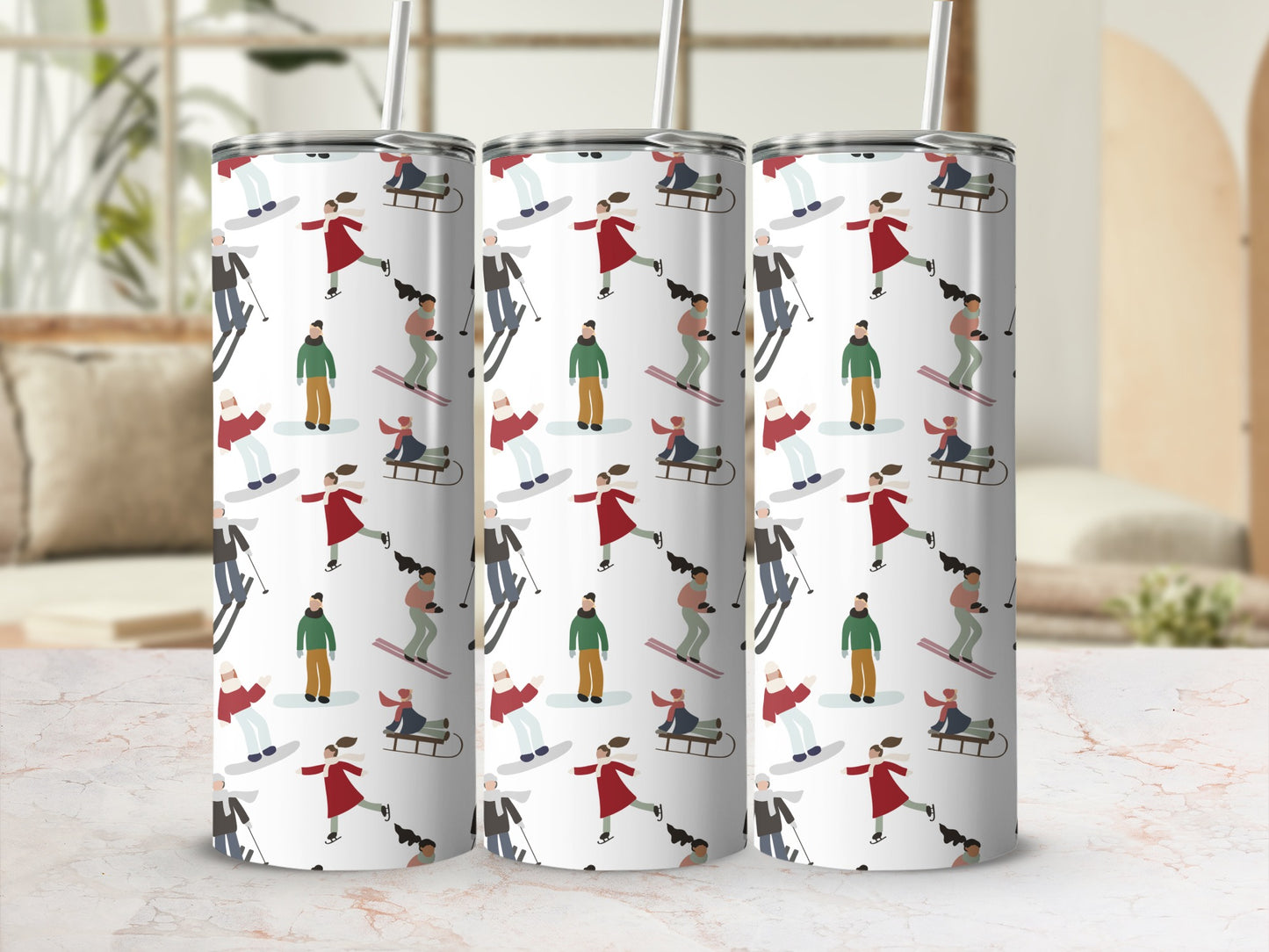 Three white tumblers with a ski-themed pattern of people skiing and snowboarding.