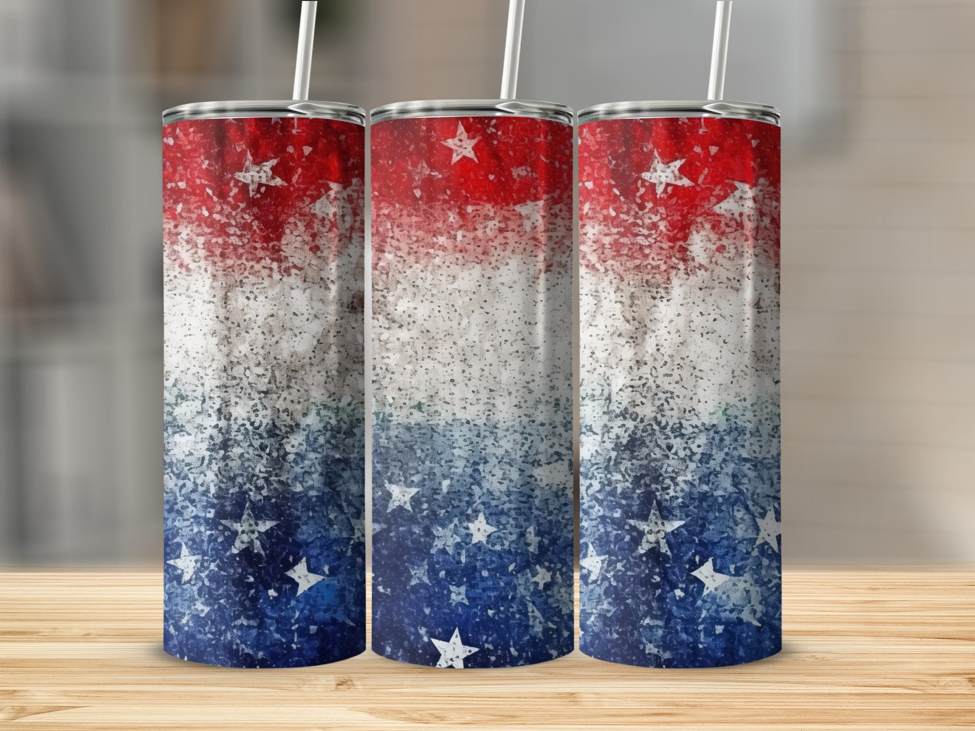 Three tumblers with patriotic red, white, and blue star and splatter design.
