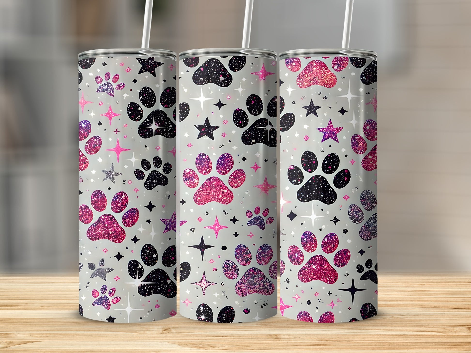 Three glittery paw print tumblers with stars on a light background.