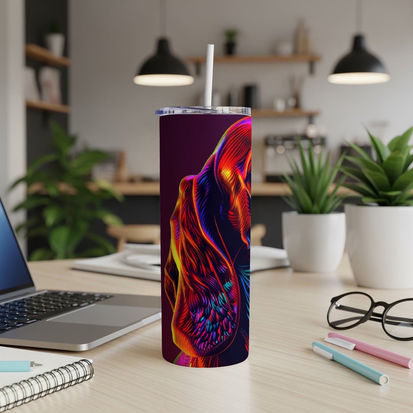 Abstract colorful dog illustration on a tall, narrow tumbler with a straw.