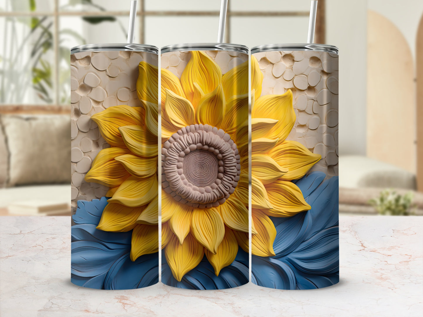 Three tumblers with a sunflower and blue petal design.
