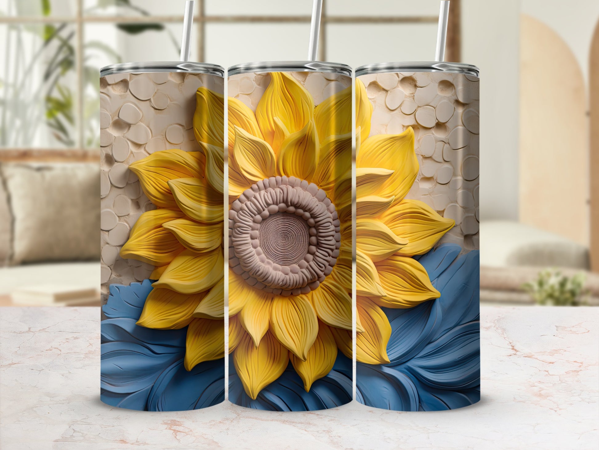 Three tumblers with a sunflower and blue petal design.