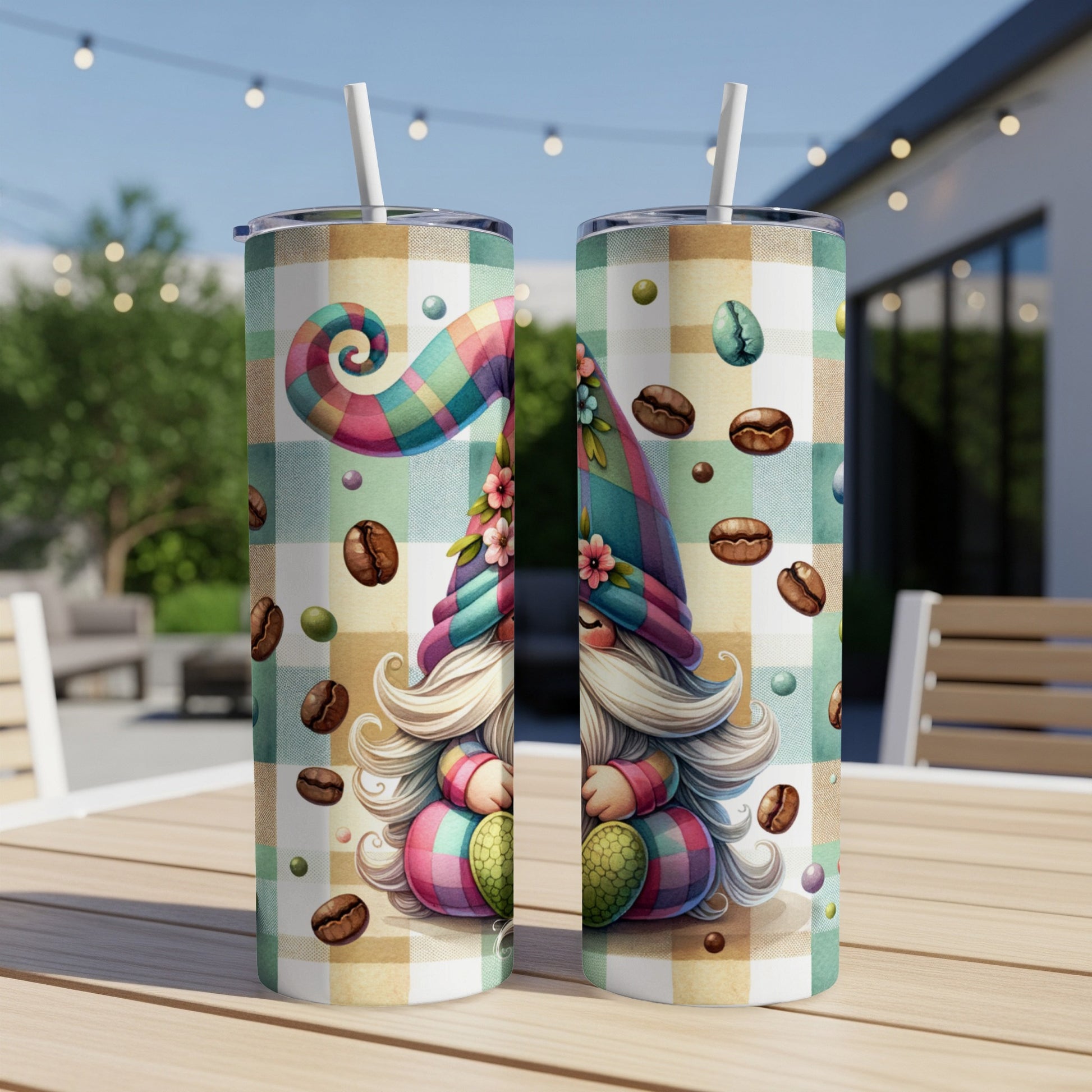 Two tumblers with a gnome design and coffee beans, on a checkered background.