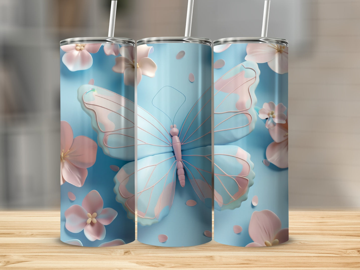 Three blue tumblers with pink butterflies and flowers.