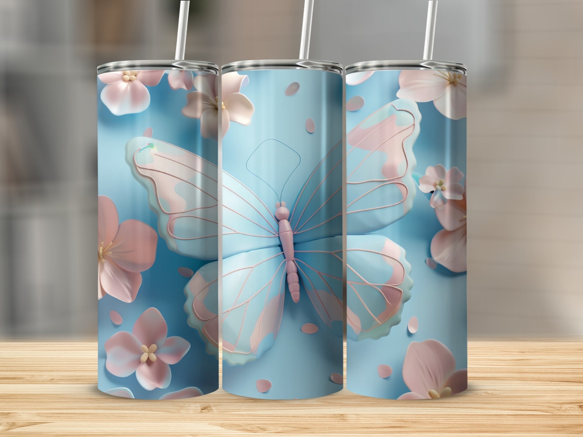 Three blue tumblers with pink butterflies and flowers.
