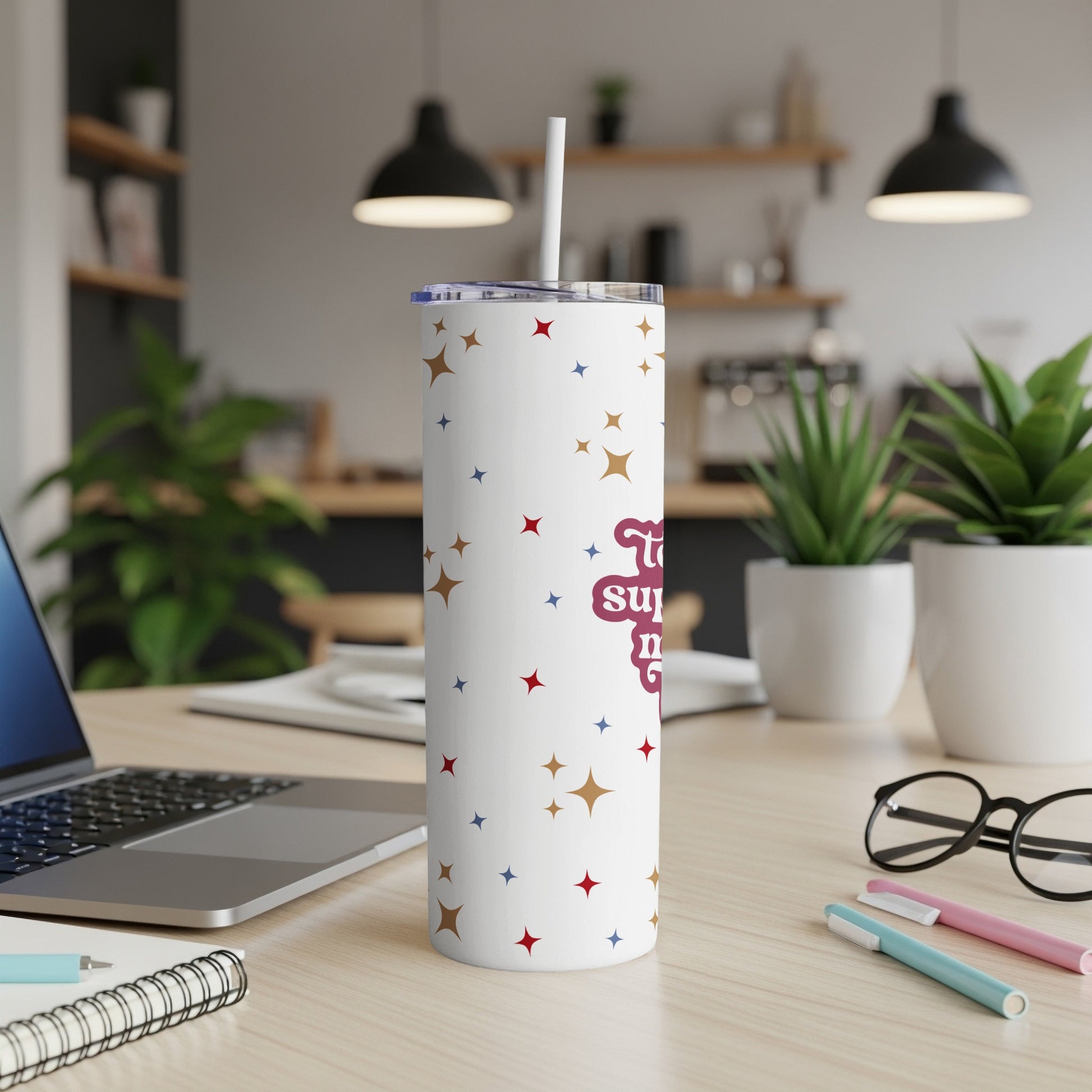 White tumbler with stars and "Today's superpower is..." text, on desk.