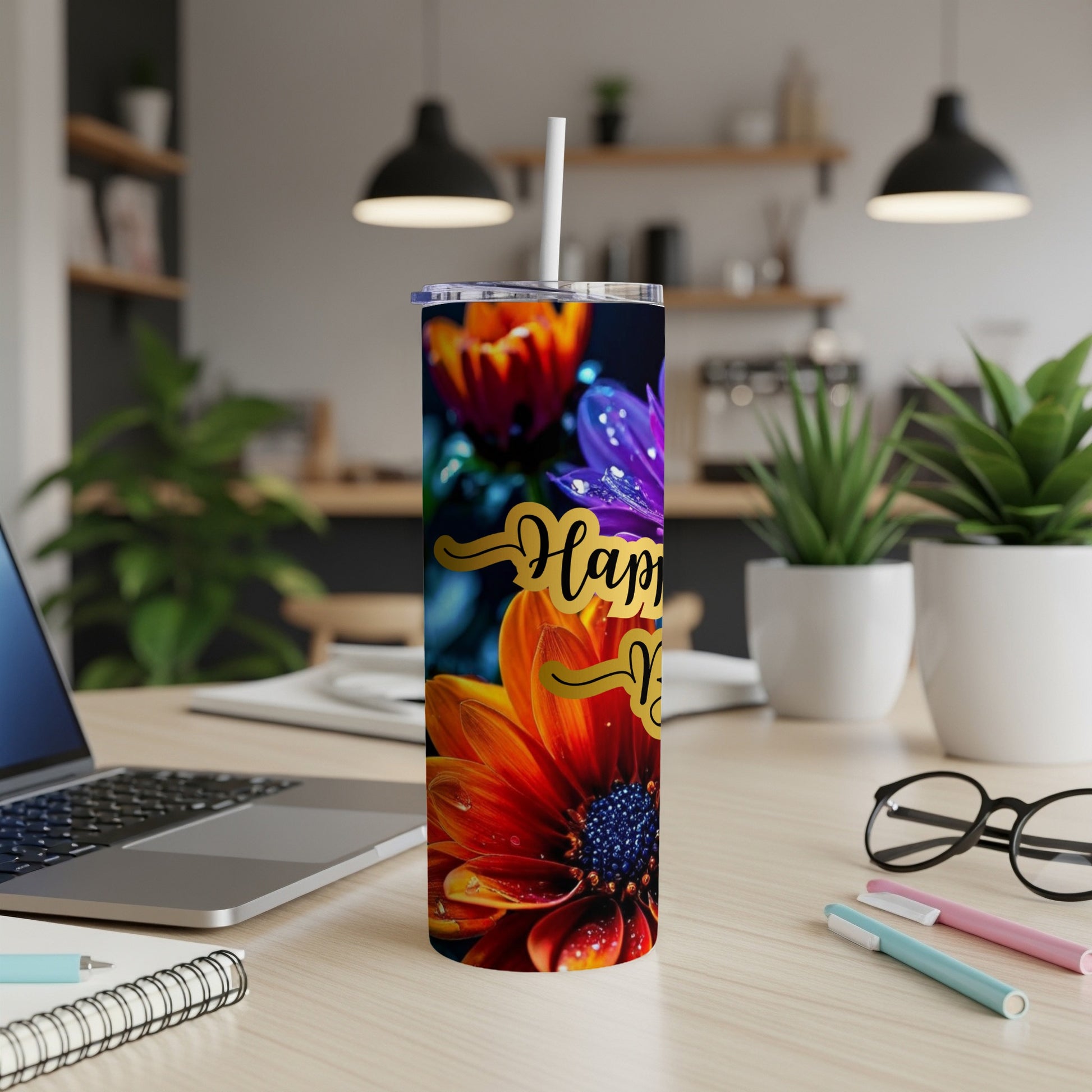 Floral tumbler with "Happy New Year" text and a straw.