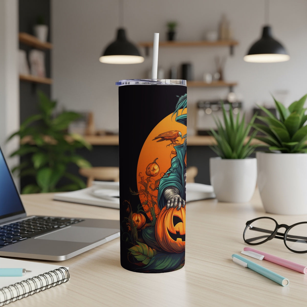 Black tumbler with Halloween scarecrow, pumpkin, and crow illustration.