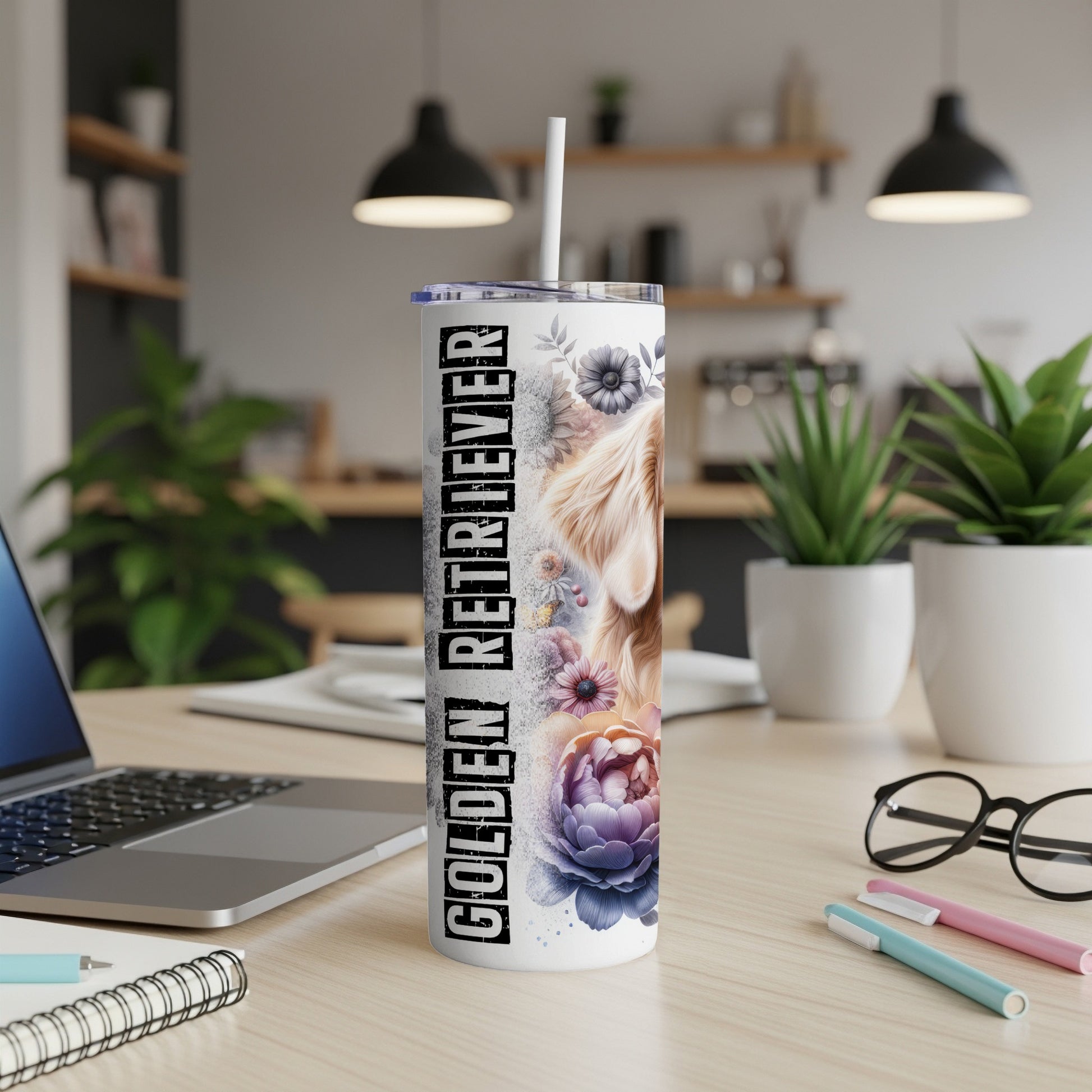 Golden Retriever tumbler with floral design and straw on a desk.