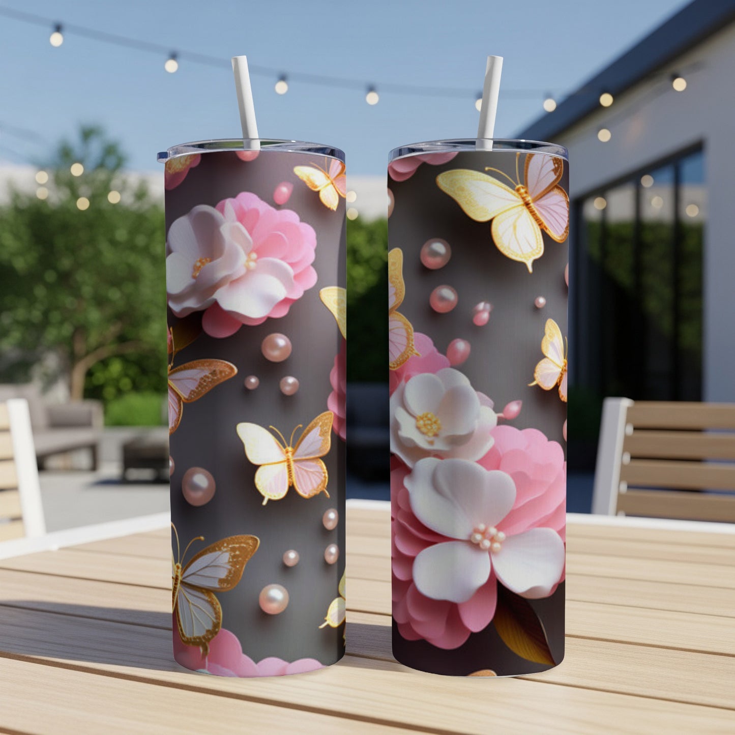 Two floral tumblers with butterflies and pearls on a dark background.