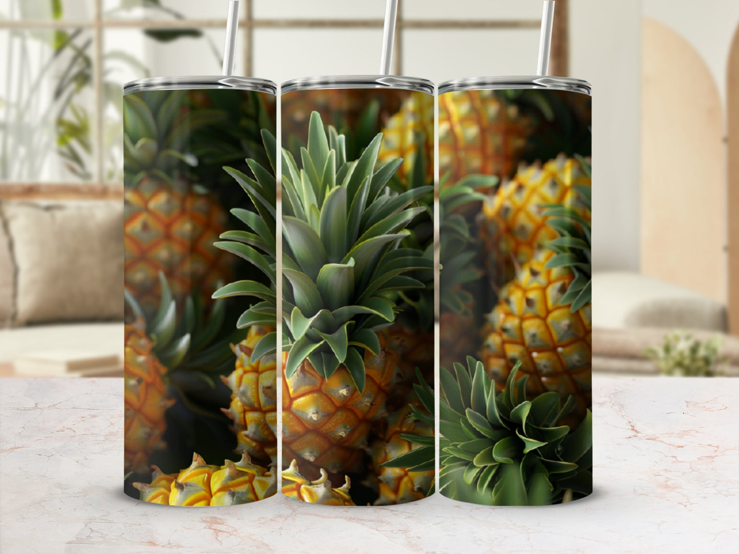 Close-up of three tumblers featuring pineapple patterns on a marble surface.