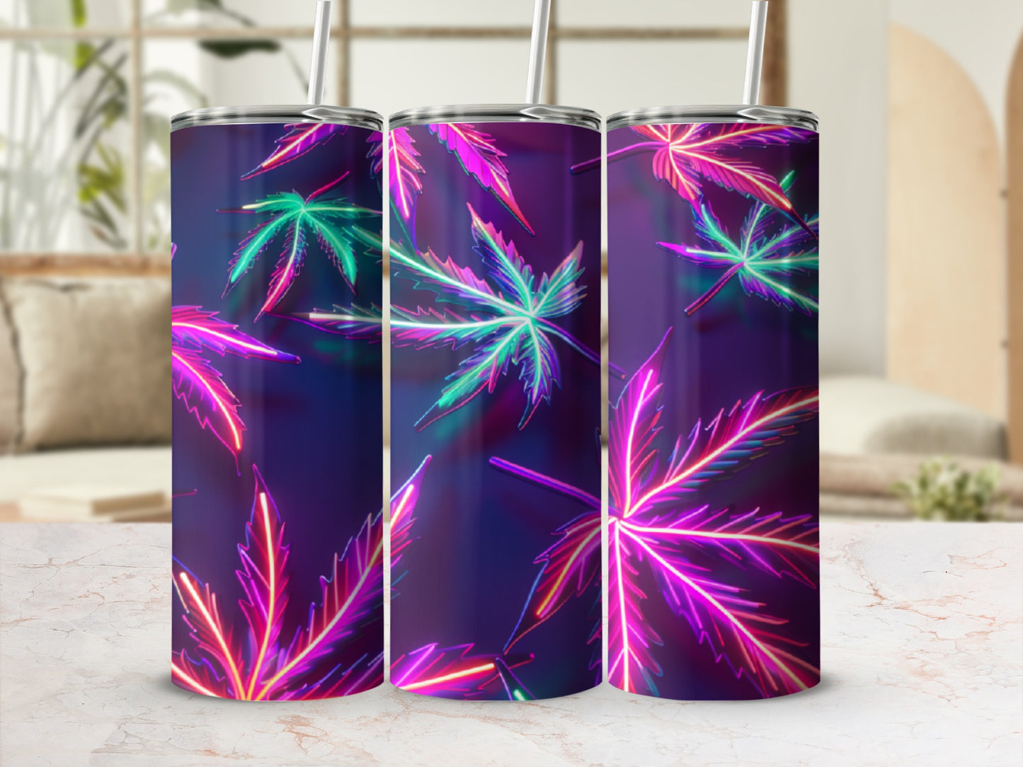 Three tumblers with neon cannabis leaf design and straws.
