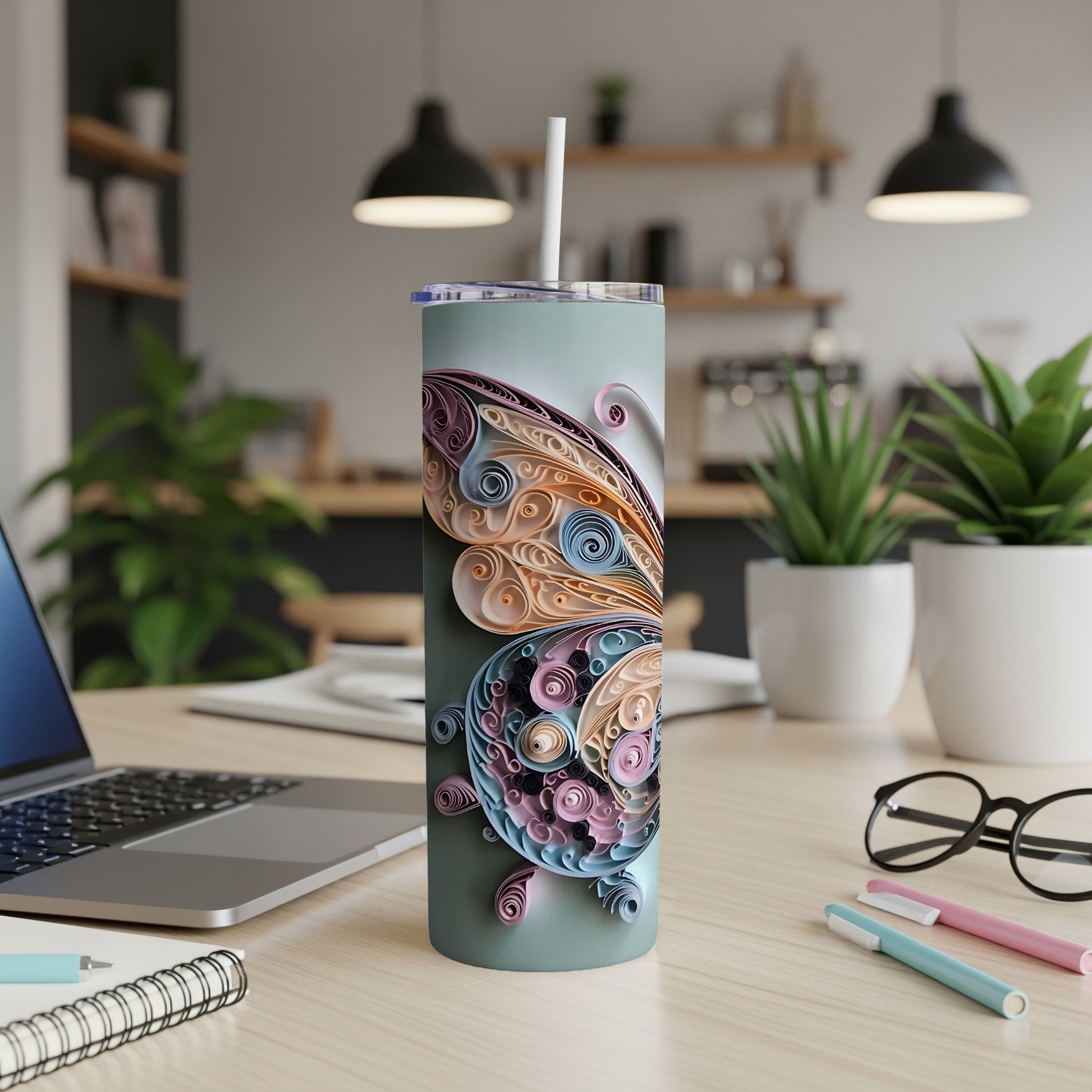 Tumbler with intricate pastel butterfly wing design and straw.