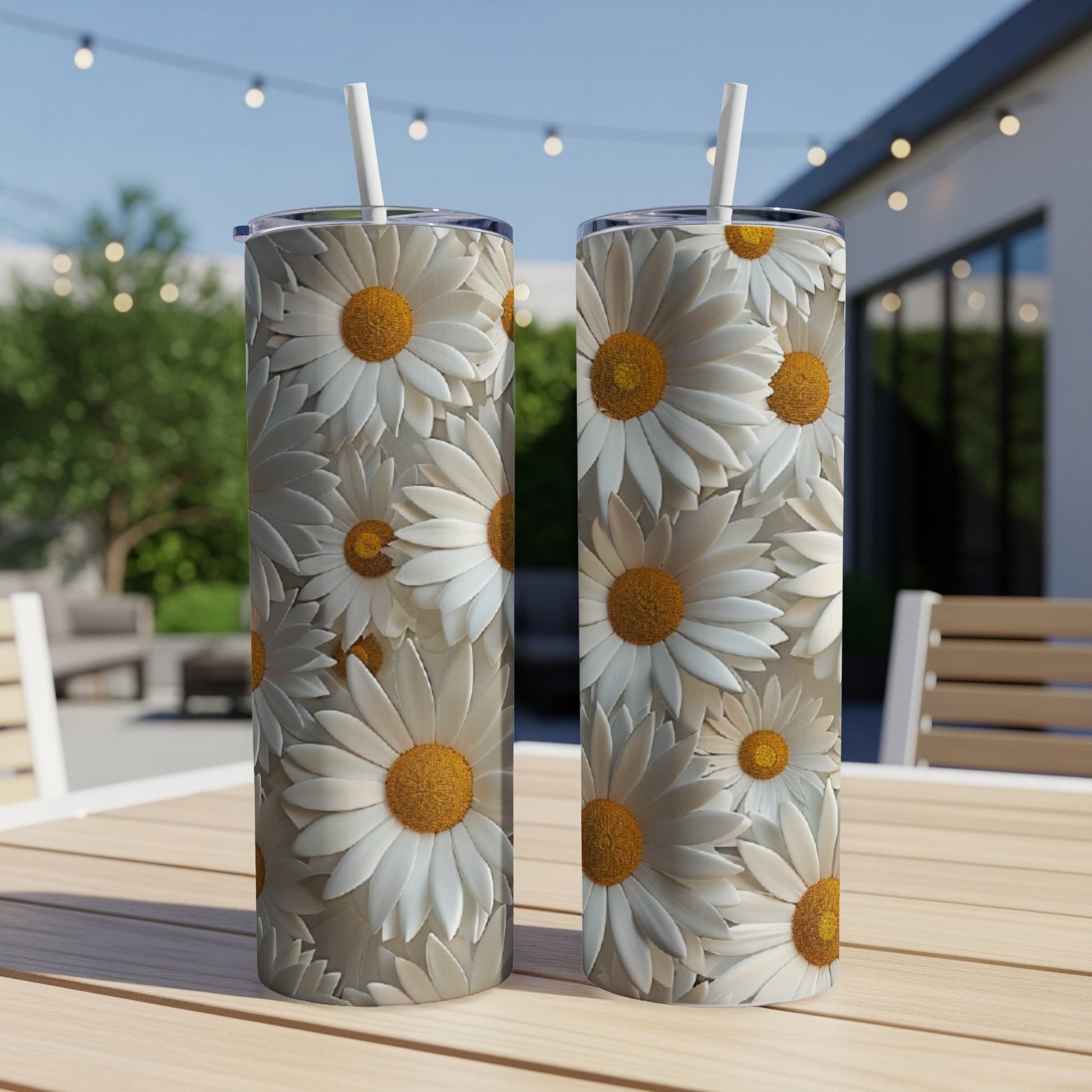 Two tall, slim tumblers with a repeating pattern of white daisies and yellow centers.