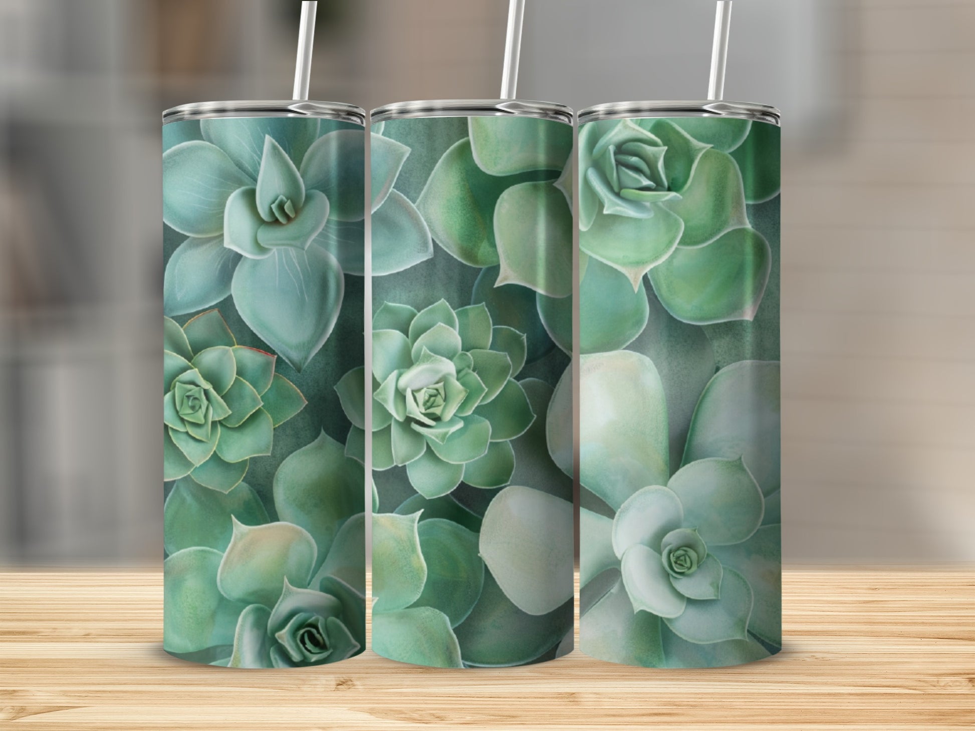 Three tumblers with a succulent plant design on a wooden surface.