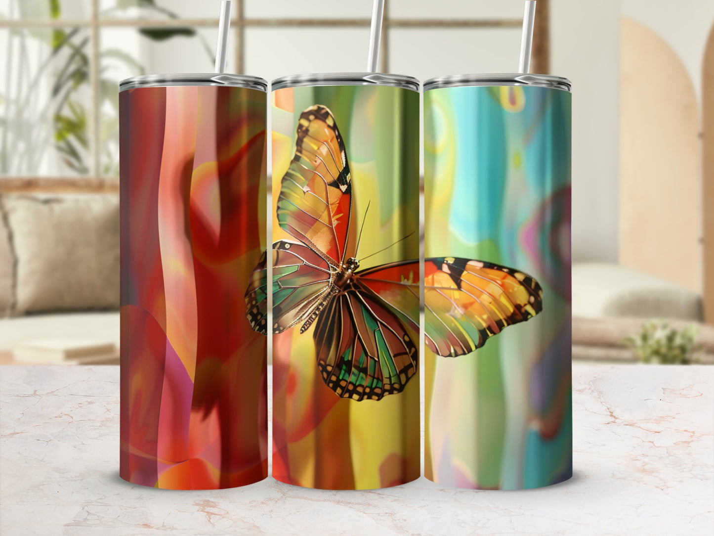 Three tumblers with colorful abstract backgrounds and a prominent butterfly design.