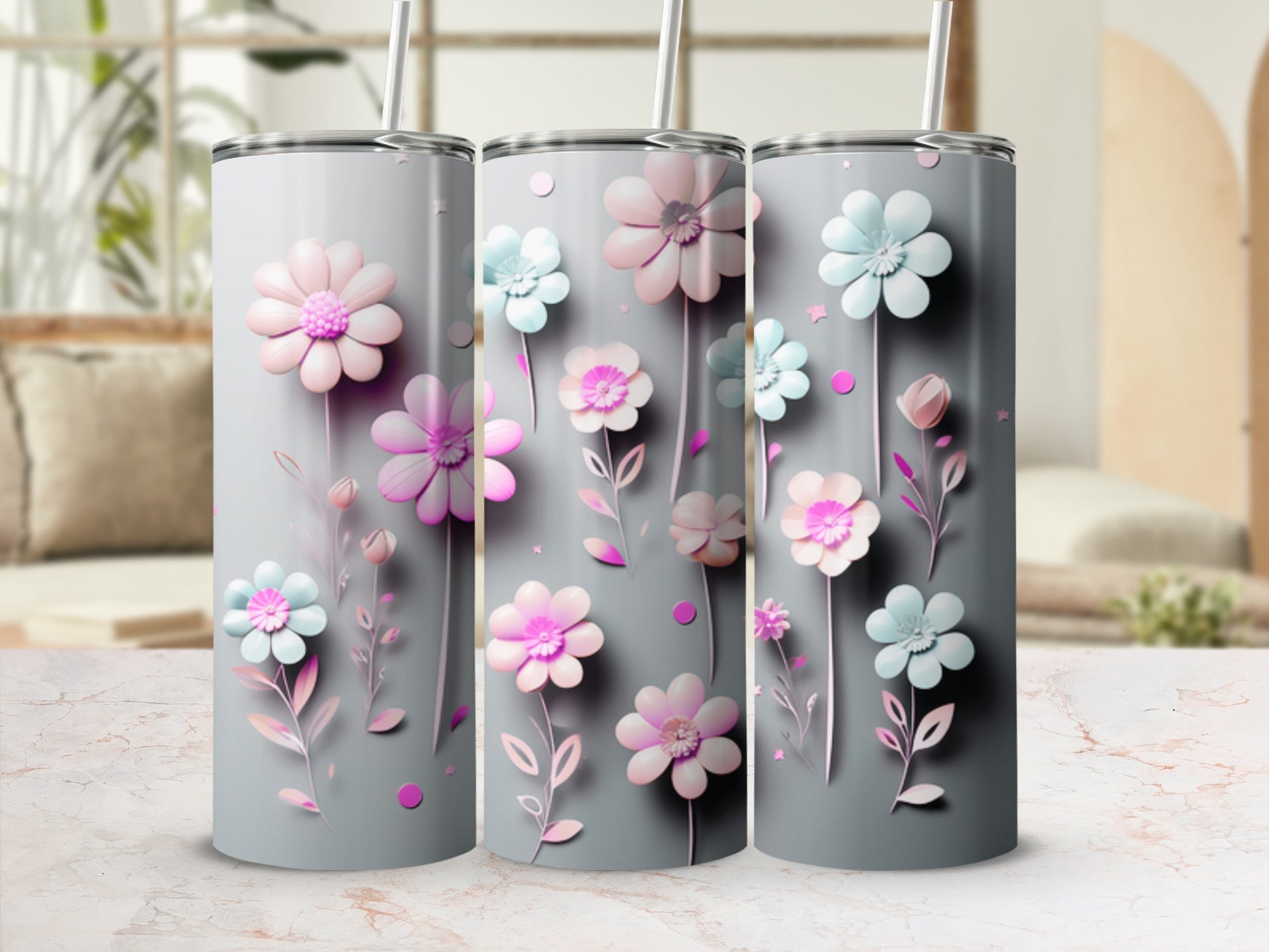 Three gray tumblers with pink and blue watercolor floral designs.