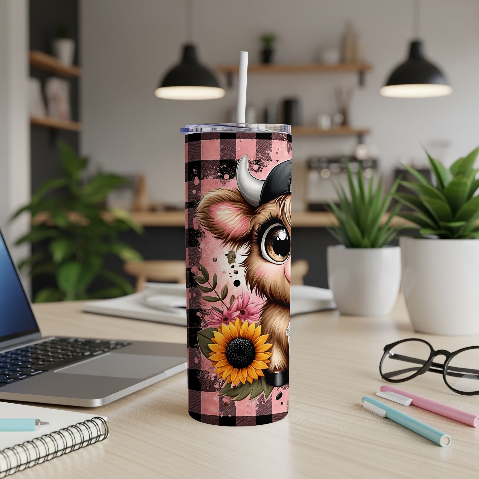 Cow with sunflower design on tumbler with straw.