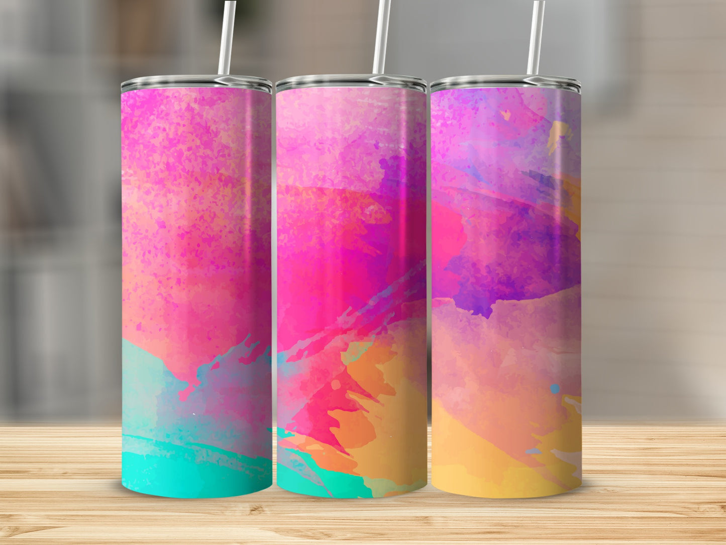 Three tumblers with colorful abstract watercolor designs and straws.