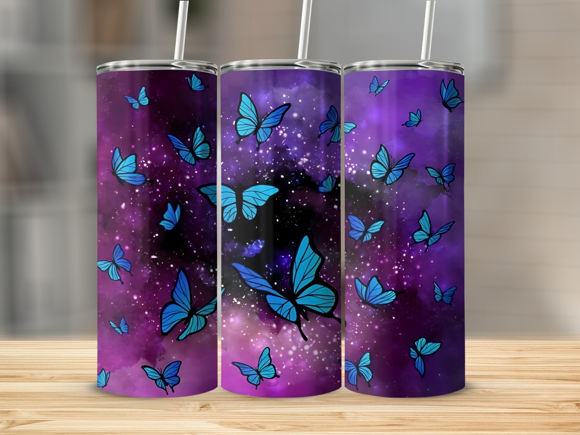 Three purple tumblers with blue butterflies and galaxy background.